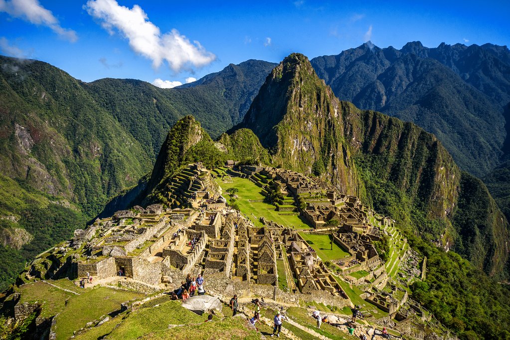 View of the Lost Incan City of Machu Picchu near Cusco, Peru. Machu Picchu is a Peruvian Historical Sanctuary. People can be seen on foreground.