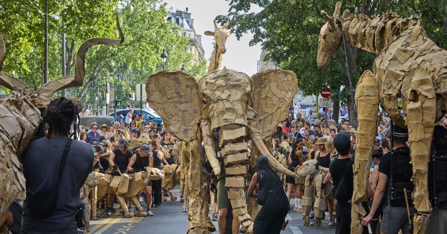 THE HERDS arrive in Paris on it's journey from Africa to the Arctic Circle. THE HERDS is a work of public art and climate action designed to ignite a renewed bond with the natural world. From April to August 2025, life-size puppet animals are sweeping through city centres on a 20,000km journey from Kinshasa in the Congo Basin to Tondheim in the Norway, fleeing climate disaster.  The journey started with 15 animals and has grown gradually since. By the time they crossed from Morocco to Spain, THE HERDS was 25 animals and in Paris THE HERDS was the biggest yet: 100 puppeteers puppeteering 40 animals. New animals have been added as THE HERDS have moved, including Vervet Monkeys in Nigeria, gazelles in Morocco.  Wolves will be added in central Europe and reindeer in Scandinavia. The Herds production team say - 'We began discussing idea of THE HERDS in early 2022, soon after our first journey with Little Amal. Whilst walking with Amal we encountered many refugees and migrants who were leaving their homes because of climate change. Our aim was to create an emotional reaction to the climate crisis. We believe that awe and beauty is the missing spark that leads us from curiosity to change. ' The cities included on THE HERDS journey are: - Kinshasa (DRC)
Lagos (Nigeria)
Dakar (Senegal)
Agafay, Marrakesh, Casablanca, Rabat (Morocco)
San Fernando and Madrid (Spain)
The Camargue, Marseille, Arles, Paris (France)
Venice (Italy)
London, Manchester, Wigan, Rochdale (UK)
Aarhus, Copenhagen (Denmark)
Stockholm (Sweden)
Trondheim (Norway) 
THE HERDS began their journey in Kinshasa on 9 April and will have their final public event in Trondheim on 30 June 2025, with details of their final steps in the Arctic Circle to be revealed. Paris, France. Photograph by David Levene 21/6/25